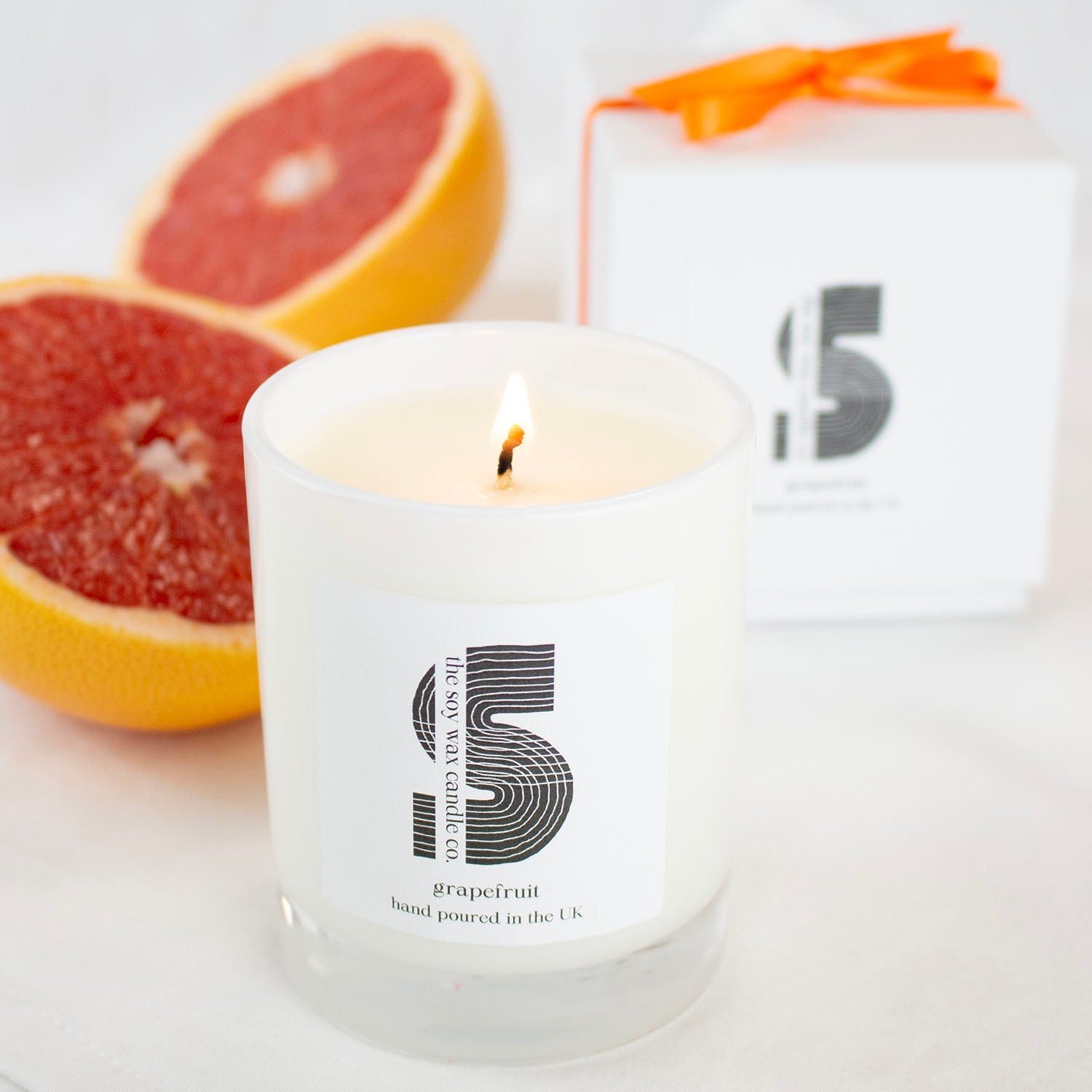 Hand poured UK 20cl soy wax grapefruit candle in white gloss jar by The Soy Wax Candle Company, natural citrus home fragrance gift.