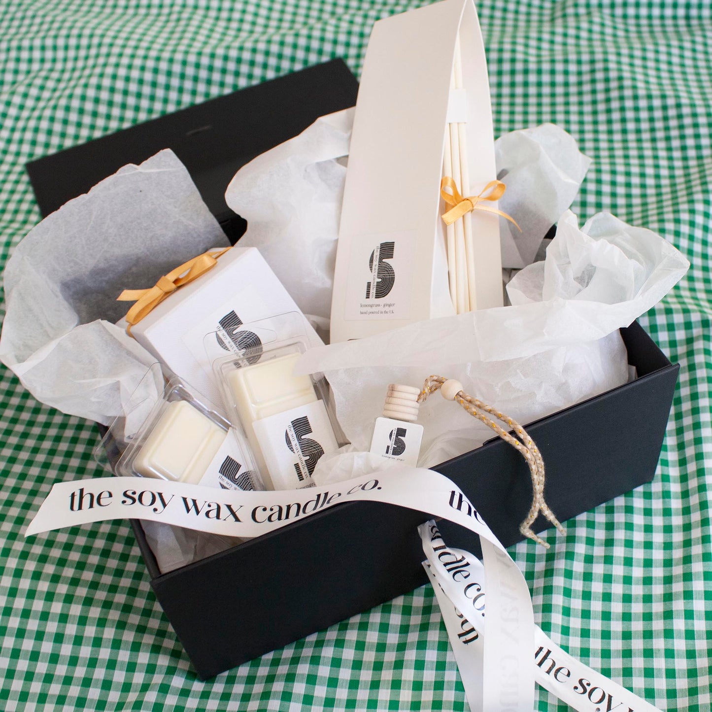 The Soy Wax Candle Company Citrus Gift Hamper containing one soy wax candle, one reed diffuser, one car diffuser and 2 soy wax melt bars.  A luxurious gift!
