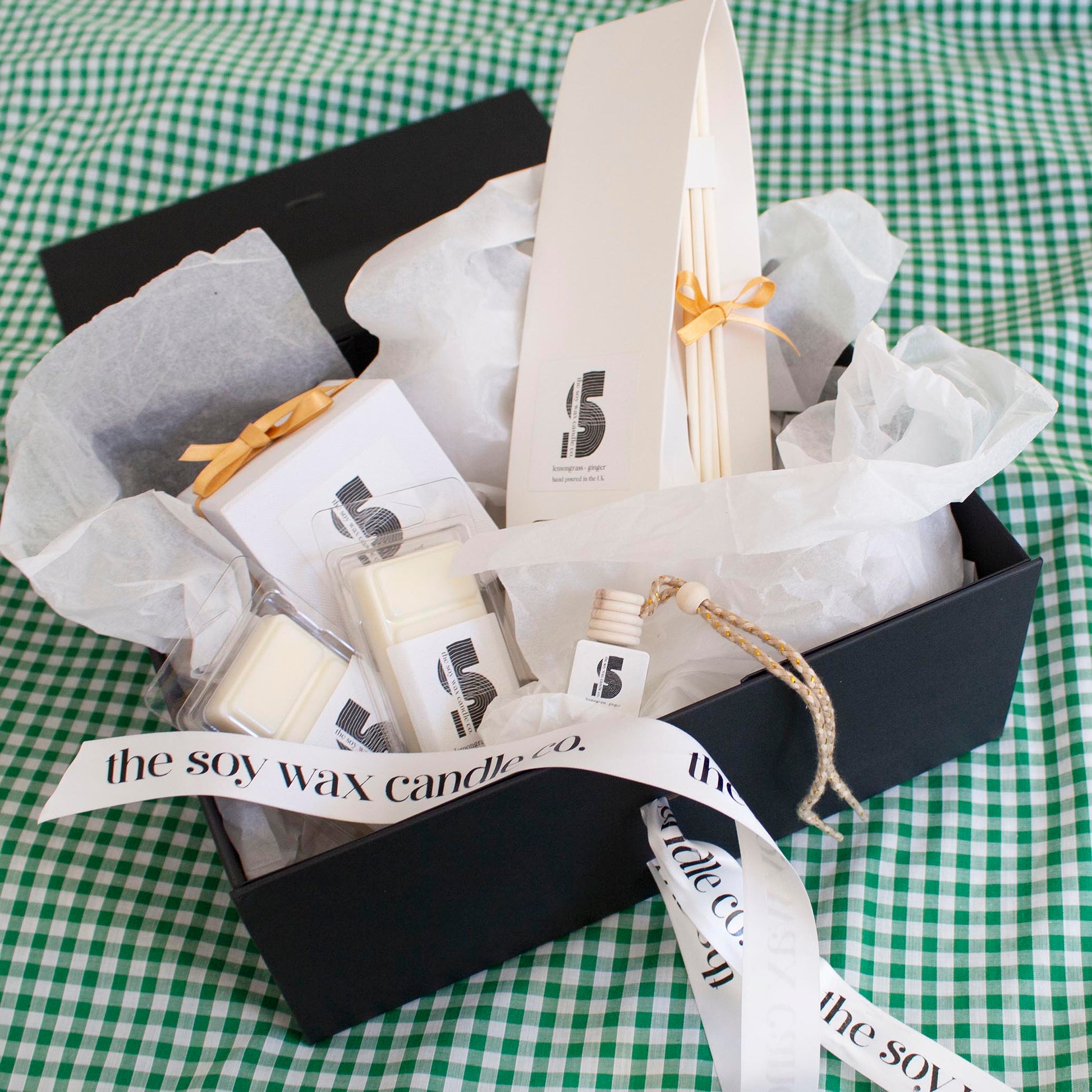 The Soy Wax Candle Company Citrus Gift Hamper containing one soy wax candle, one reed diffuser, one car diffuser and 2 soy wax melt bars.  A luxurious gift!