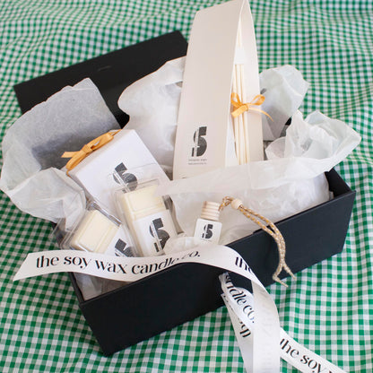 The Soy Wax Candle Company Citrus Gift Hamper containing one soy wax candle, one reed diffuser, one car diffuser and 2 soy wax melt bars.  A luxurious gift!
