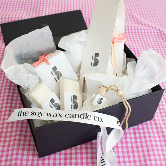 The Soy Wax Candle Company Floral Gift Hamper containing one soy wax candle, one reed diffuser, one car diffuser and 2 soy wax melt bars.  A luxurious gift!
