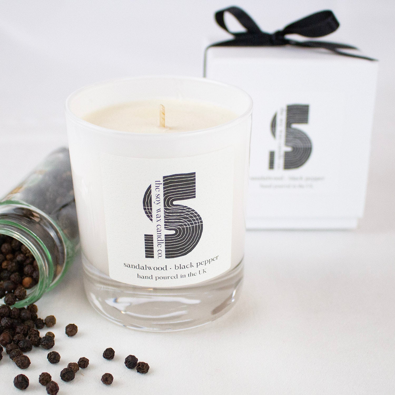 A Sandalwood & Black Pepper Soy Wax Candle in a White Gloss Candle Jar.