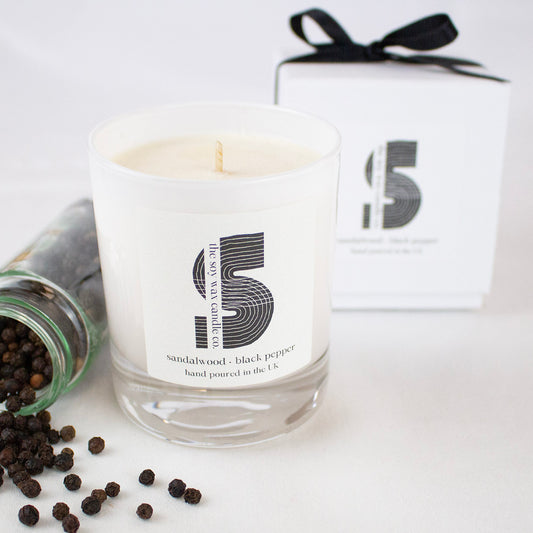 A Sandalwood & Black Pepper Soy Wax Candle in a White Gloss Candle Jar.